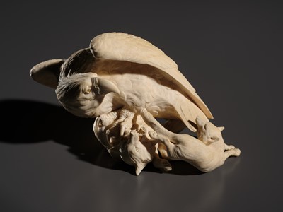 TOMOKAZU: A SUPERB IVORY OKIMONO OF AN EAGLE WITH TWO FOXES