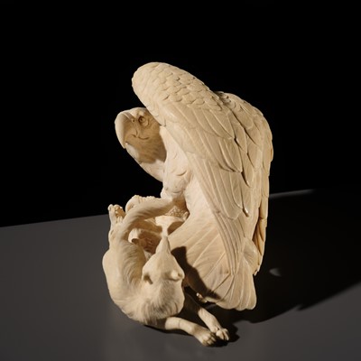 TOMOKAZU: A SUPERB IVORY OKIMONO OF AN EAGLE WITH TWO FOXES