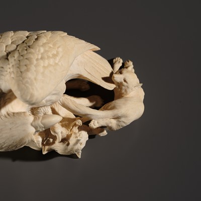 TOMOKAZU: A SUPERB IVORY OKIMONO OF AN EAGLE WITH TWO FOXES