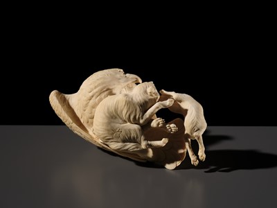 TOMOKAZU: A SUPERB IVORY OKIMONO OF AN EAGLE WITH TWO FOXES