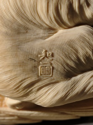 TOMOKAZU: A SUPERB IVORY OKIMONO OF AN EAGLE WITH TWO FOXES
