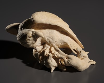 TOMOKAZU: A SUPERB IVORY OKIMONO OF AN EAGLE WITH TWO FOXES