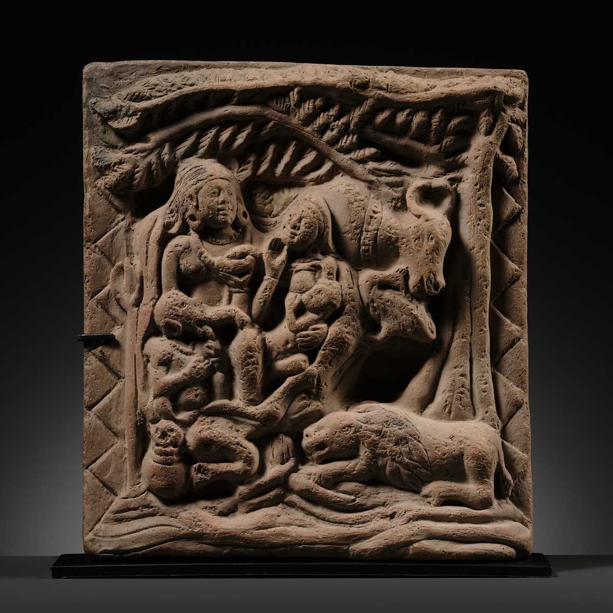 A TERRACOTTA PLAQUE DEPICTING SHIVA, PARVATI, GANESHA, AND KARTIKEYA WITH THEIR VEHICLES, UTTAR PRADESH, INDIA, 8TH-12TH CENTURY