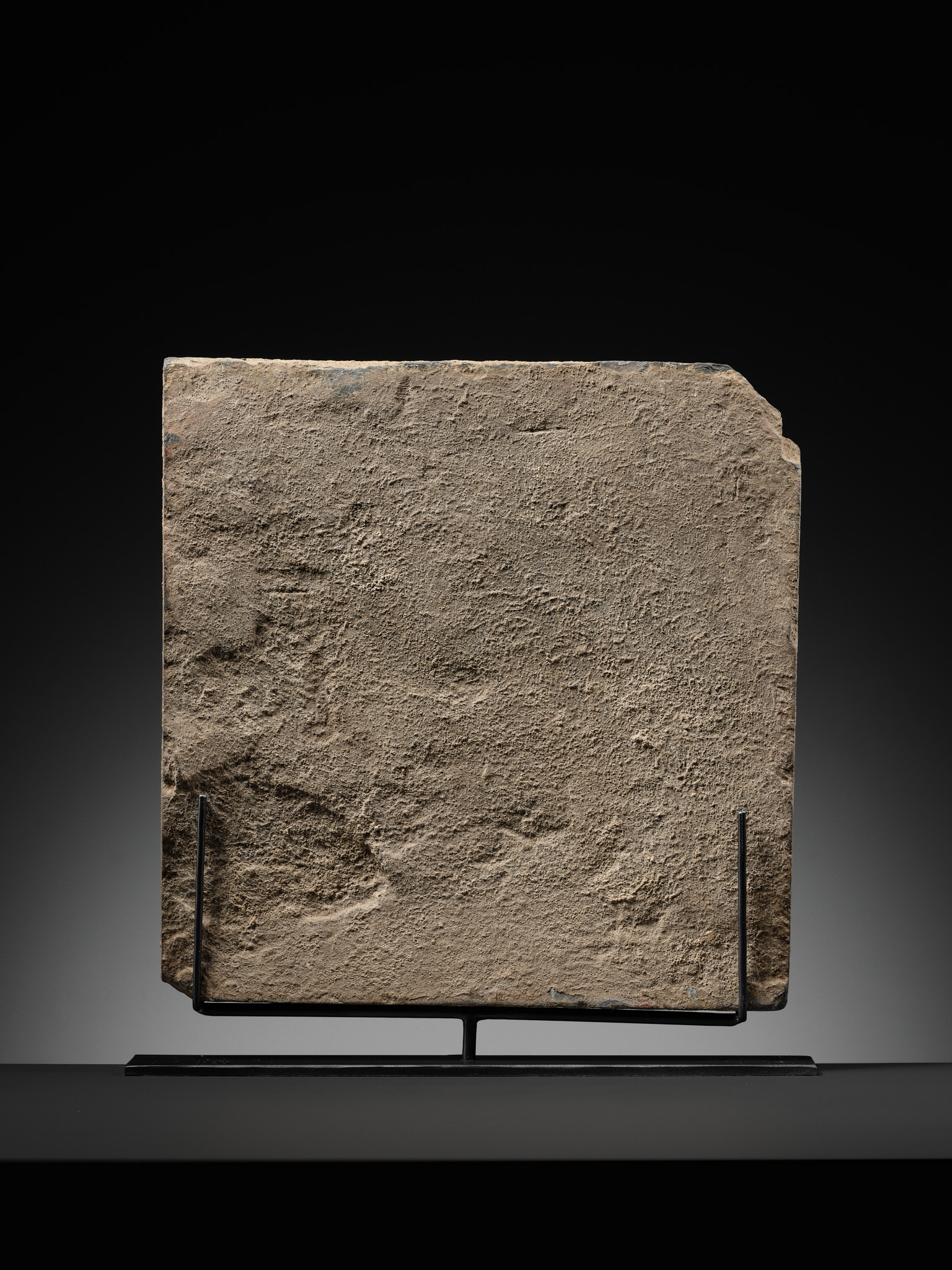 Lot 186 - A RARE GRAY SCHIST RELIEF OF THE FOOTPRINTS