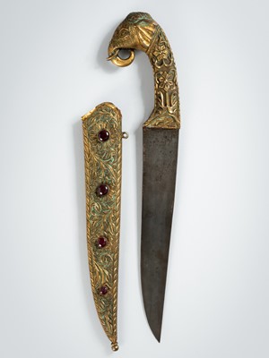 Lot 1269 - A MUGHAL-STYLE GILT-REPOUSSÉ ‘ELEPHANT’ DAGGER AND SCABBARD, KHAJAR, c. 1900s