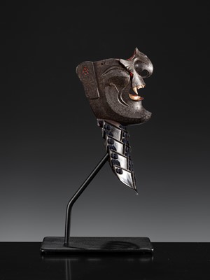 Lot 88 - A LACQUERED IRON ‘FANGED’ RESSEI MENPO