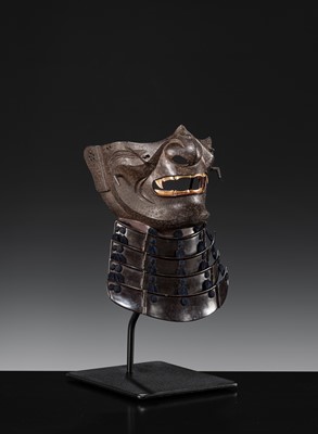 Lot 88 - A LACQUERED IRON ‘FANGED’ RESSEI MENPO