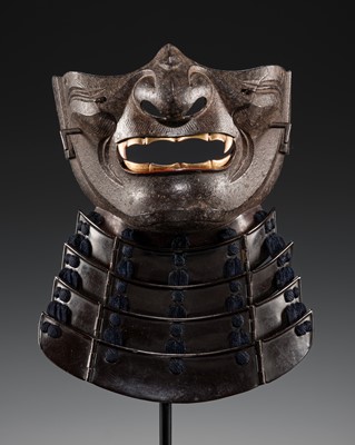 Lot 88 - A LACQUERED IRON ‘FANGED’ RESSEI MENPO