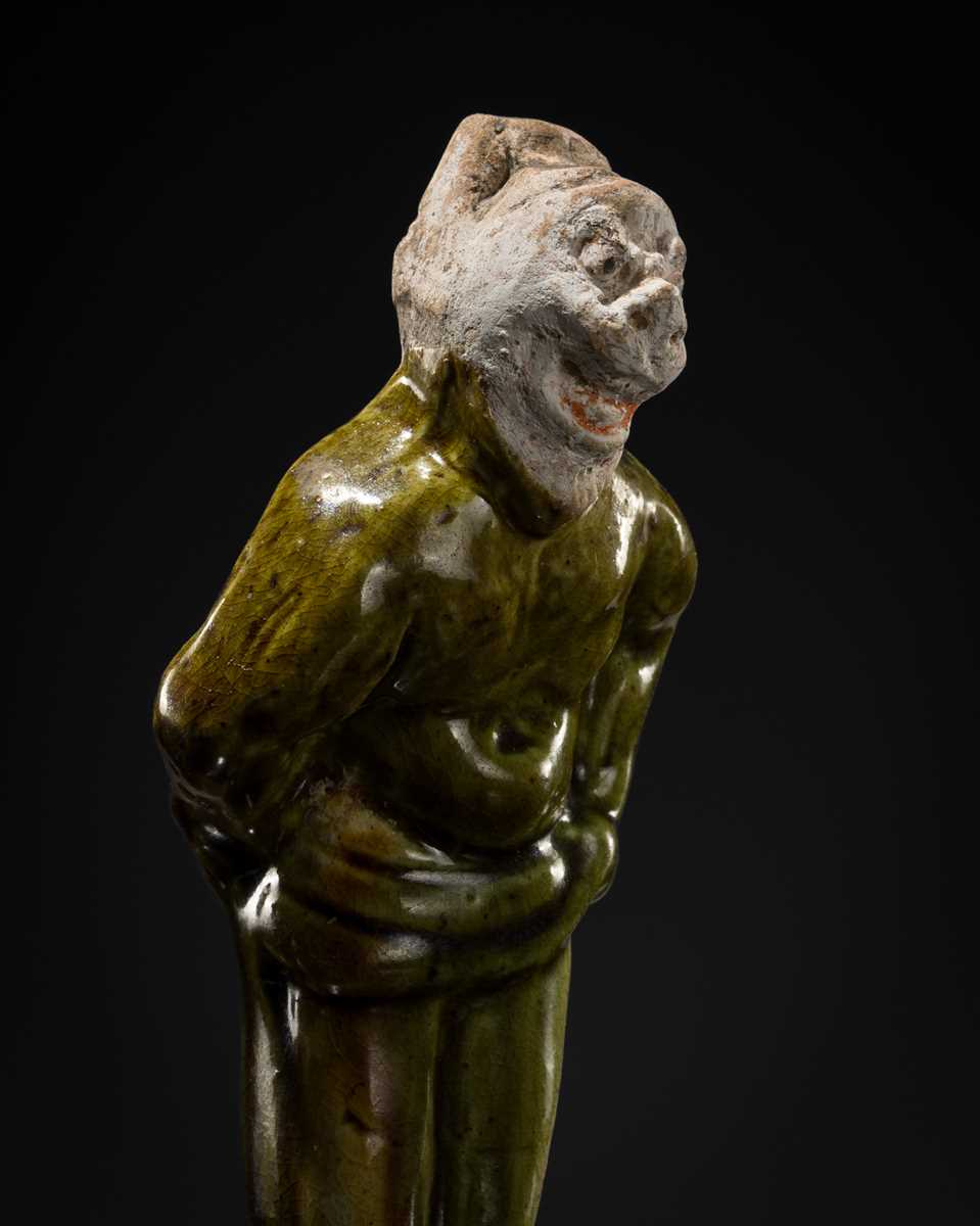 Lot 1078 - A SMALL SANCAI-GLAZED POTTERY FIGURE OF A FOREIGNER, TANG DYNASTY