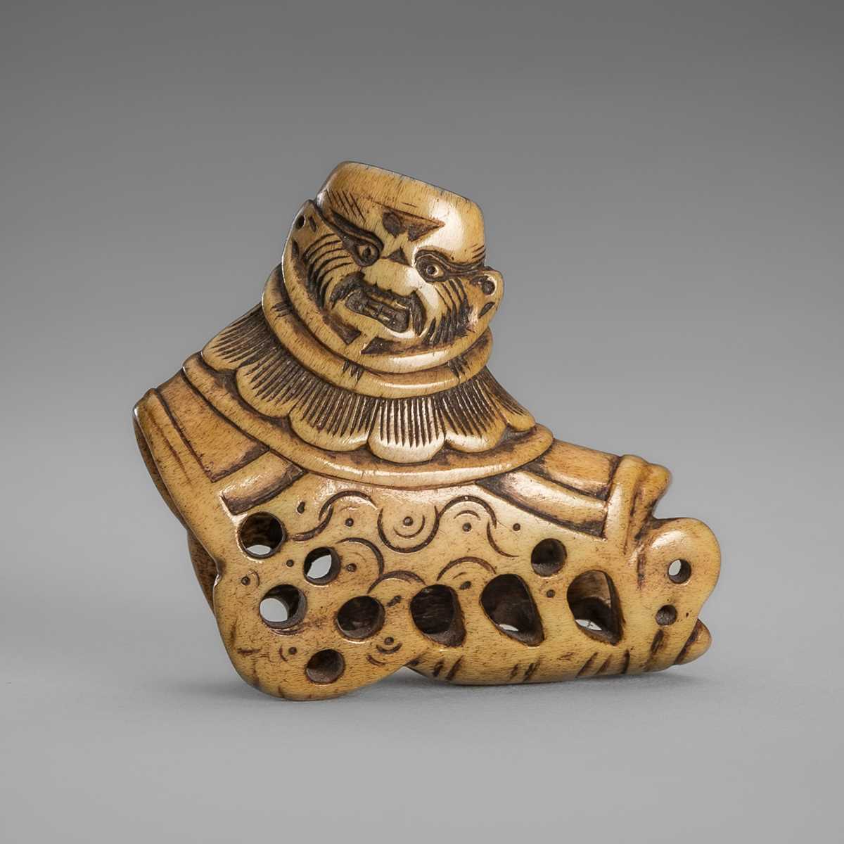 Lot 459 - A FINE ANTLER ‘SILK SEAL’ NETSUKE OF A FOREIGNER