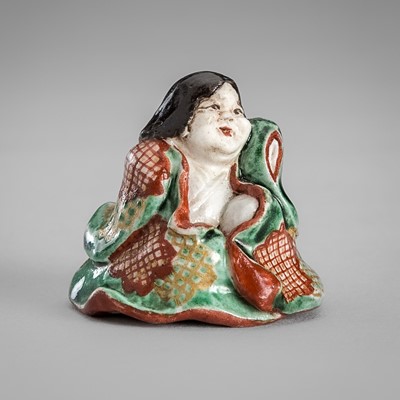 Lot 486 - A PORCELAIN SHUNGA NETSUKE OF OKAME, AFTER NIN’AMI DOHACHI