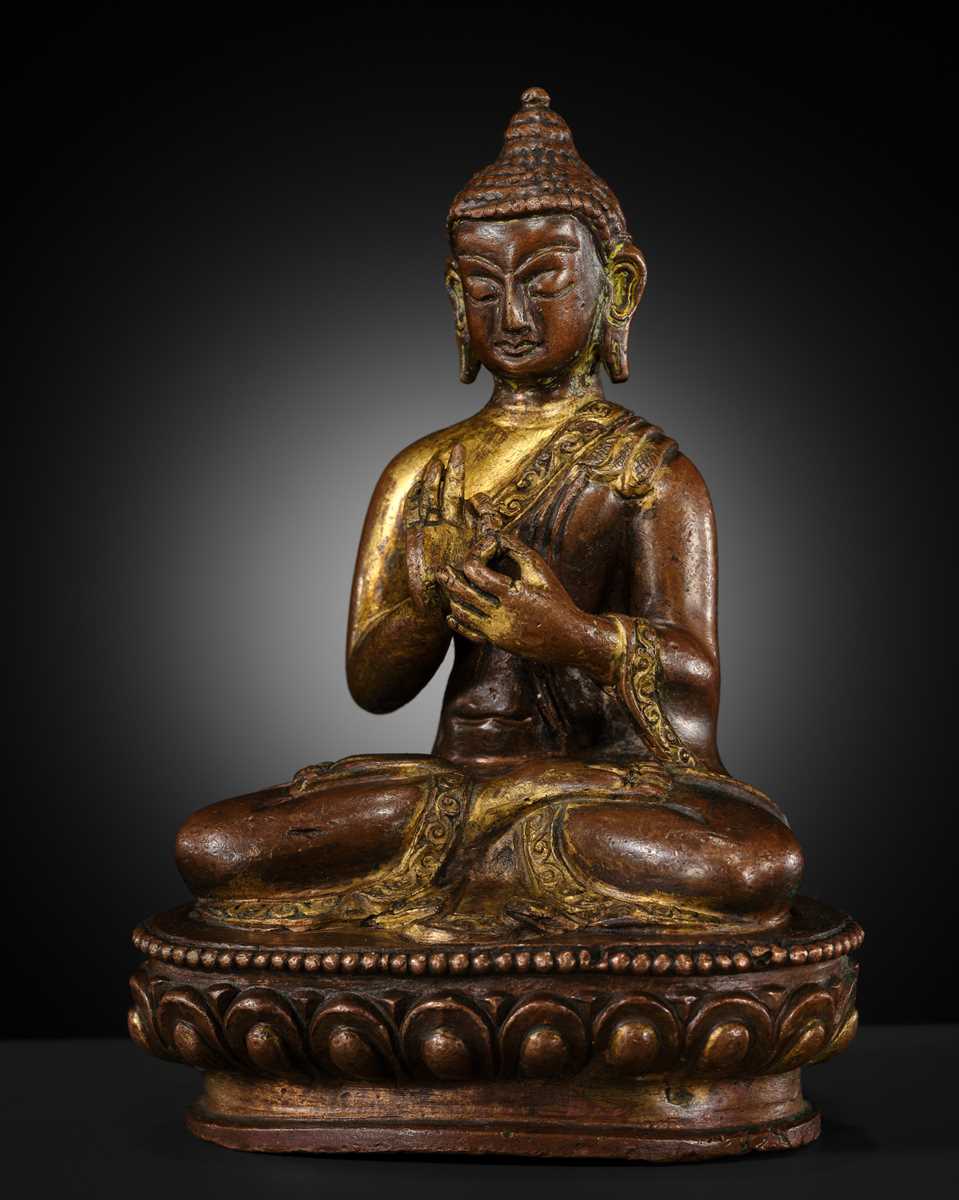 A SMALL PARCEL-GILT COPPER ALLOY FIGURE OF BUDDHA, TIBET OR NEPAL, 17TH-18TH CENTURY