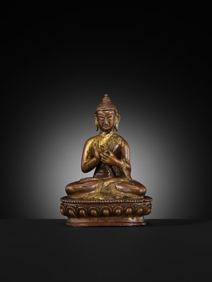 A SMALL PARCEL-GILT COPPER ALLOY FIGURE OF BUDDHA, TIBET OR NEPAL, 17TH-18TH CENTURY