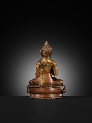 A SMALL PARCEL-GILT COPPER ALLOY FIGURE OF BUDDHA, TIBET OR NEPAL, 17TH-18TH CENTURY