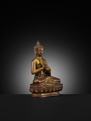 A SMALL PARCEL-GILT COPPER ALLOY FIGURE OF BUDDHA, TIBET OR NEPAL, 17TH-18TH CENTURY