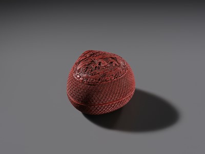 Lot 115 - A CINNABAR LACQUER PEACH-FORM BOX AND COVER DEPICTING SHOULAO, 18TH CENTURY