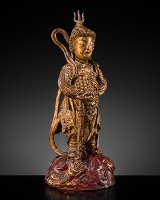 A RED AND GILT-LACQUERED BRONZE FIGURE OF WEITUO PUSA, MING DYNASTY