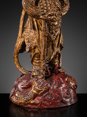 A RED AND GILT-LACQUERED BRONZE FIGURE OF WEITUO PUSA, MING DYNASTY