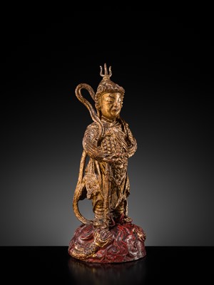 A RED AND GILT-LACQUERED BRONZE FIGURE OF WEITUO PUSA, MING DYNASTY