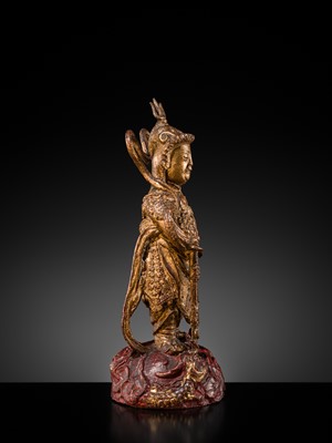 A RED AND GILT-LACQUERED BRONZE FIGURE OF WEITUO PUSA, MING DYNASTY