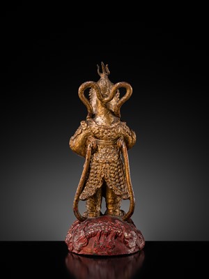 A RED AND GILT-LACQUERED BRONZE FIGURE OF WEITUO PUSA, MING DYNASTY