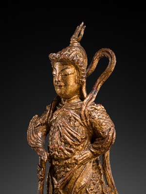 A RED AND GILT-LACQUERED BRONZE FIGURE OF WEITUO PUSA, MING DYNASTY