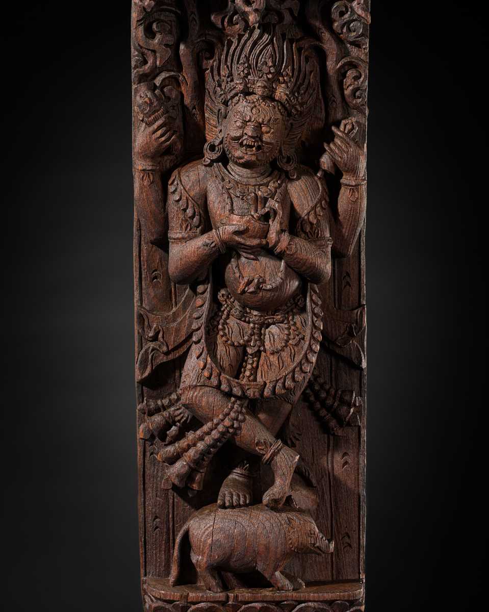 A WOOD STRUT DEPICTING THE FOUR-ARMED BHAIRAVA ATOP A BOAR, NEPAL, 17TH-18TH CENTURY