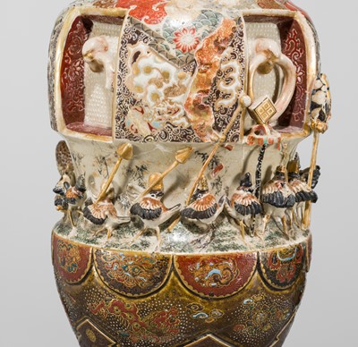 MAKUZU KOZAN: A GROUP OF FOUR LARGE MOLDED, GILT-DECORATED AND ENAMELED EARTHENWARE VASES WITH FROLICKING ANIMALS