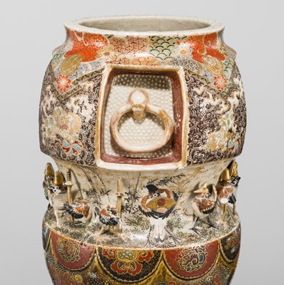 MAKUZU KOZAN: A GROUP OF FOUR LARGE MOLDED, GILT-DECORATED AND ENAMELED EARTHENWARE VASES WITH FROLICKING ANIMALS