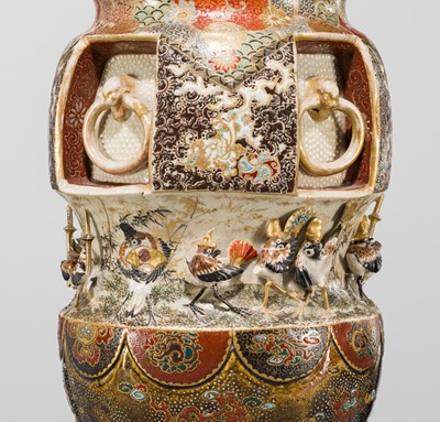 MAKUZU KOZAN: A GROUP OF FOUR LARGE MOLDED, GILT-DECORATED AND ENAMELED EARTHENWARE VASES WITH FROLICKING ANIMALS