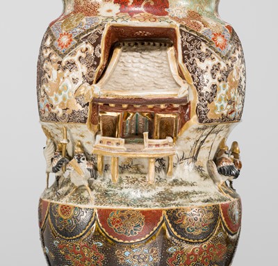 MAKUZU KOZAN: A GROUP OF FOUR LARGE MOLDED, GILT-DECORATED AND ENAMELED EARTHENWARE VASES WITH FROLICKING ANIMALS