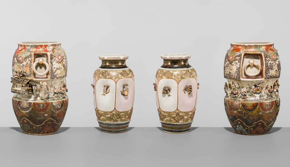 MAKUZU KOZAN: A GROUP OF FOUR LARGE MOLDED, GILT-DECORATED AND ENAMELED EARTHENWARE VASES WITH FROLICKING ANIMALS