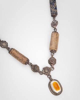 Lot 1291 - A LAPIS LAZULI AND ROCK CRYSTAL SILVER NECKLACE WITH A BUDDHA’S EYE PENDANT