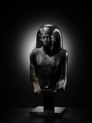 Lot 10 - AN IMPORTANT AND INSCRIBED BASALT BUST OF THE PRIEST AMUN PA-KHAR-KHONSU, PROPHET OF UASET THE VICTORIOUS, THEBES, EARLY PTOLEMAIC PERIOD