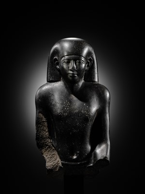 Lot 10 - AN IMPORTANT AND INSCRIBED BASALT BUST OF THE PRIEST AMUN PA-KHAR-KHONSU, PROPHET OF UASET THE VICTORIOUS, THEBES, EARLY PTOLEMAIC PERIOD