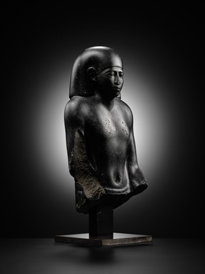 Lot 10 - AN IMPORTANT AND INSCRIBED BASALT BUST OF THE PRIEST AMUN PA-KHAR-KHONSU, PROPHET OF UASET THE VICTORIOUS, THEBES, EARLY PTOLEMAIC PERIOD