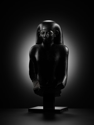 Lot 10 - AN IMPORTANT AND INSCRIBED BASALT BUST OF THE PRIEST AMUN PA-KHAR-KHONSU, PROPHET OF UASET THE VICTORIOUS, THEBES, EARLY PTOLEMAIC PERIOD