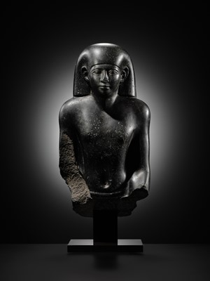 Lot 10 - AN IMPORTANT AND INSCRIBED BASALT BUST OF THE PRIEST AMUN PA-KHAR-KHONSU, PROPHET OF UASET THE VICTORIOUS, THEBES, EARLY PTOLEMAIC PERIOD