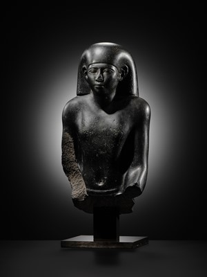 Lot 10 - AN IMPORTANT AND INSCRIBED BASALT BUST OF THE PRIEST AMUN PA-KHAR-KHONSU, PROPHET OF UASET THE VICTORIOUS, THEBES, EARLY PTOLEMAIC PERIOD