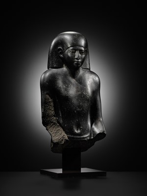 Lot 10 - AN IMPORTANT AND INSCRIBED BASALT BUST OF THE PRIEST AMUN PA-KHAR-KHONSU, PROPHET OF UASET THE VICTORIOUS, THEBES, EARLY PTOLEMAIC PERIOD