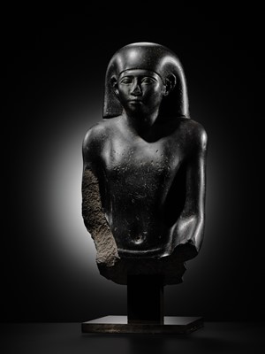 Lot 10 - AN IMPORTANT AND INSCRIBED BASALT BUST OF THE PRIEST AMUN PA-KHAR-KHONSU, PROPHET OF UASET THE VICTORIOUS, THEBES, EARLY PTOLEMAIC PERIOD