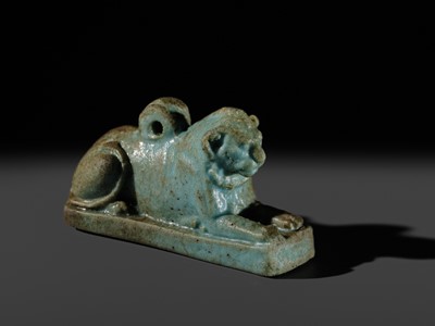 Lot 52 - A TURQUOISE-GLAZED FAIENCE AMULET OF A RECUMBENT LION, LATE PERIOD