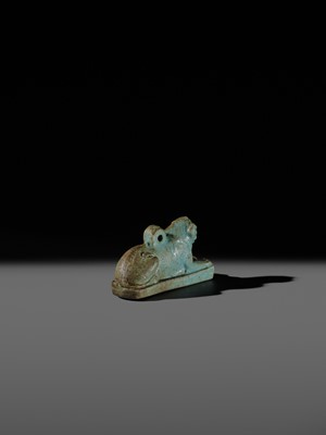 Lot 52 - A TURQUOISE-GLAZED FAIENCE AMULET OF A RECUMBENT LION, LATE PERIOD