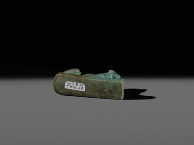 Lot 52 - A TURQUOISE-GLAZED FAIENCE AMULET OF A RECUMBENT LION, LATE PERIOD