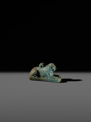 Lot 52 - A TURQUOISE-GLAZED FAIENCE AMULET OF A RECUMBENT LION, LATE PERIOD