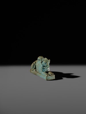 Lot 52 - A TURQUOISE-GLAZED FAIENCE AMULET OF A RECUMBENT LION, LATE PERIOD