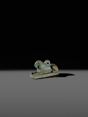 Lot 52 - A TURQUOISE-GLAZED FAIENCE AMULET OF A RECUMBENT LION, LATE PERIOD