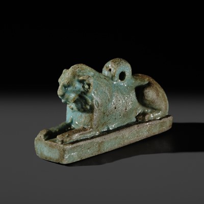 Lot 52 - A TURQUOISE-GLAZED FAIENCE AMULET OF A RECUMBENT LION, LATE PERIOD