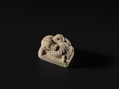 Lot 44 - A WHITE LIMESTONE AMULET OF SOBEK, PTOLEMAIC PERIOD