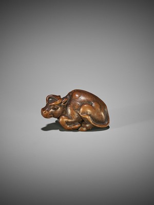 KOKEI: A WOOD NETSUKE OF A RECUMBENT OX